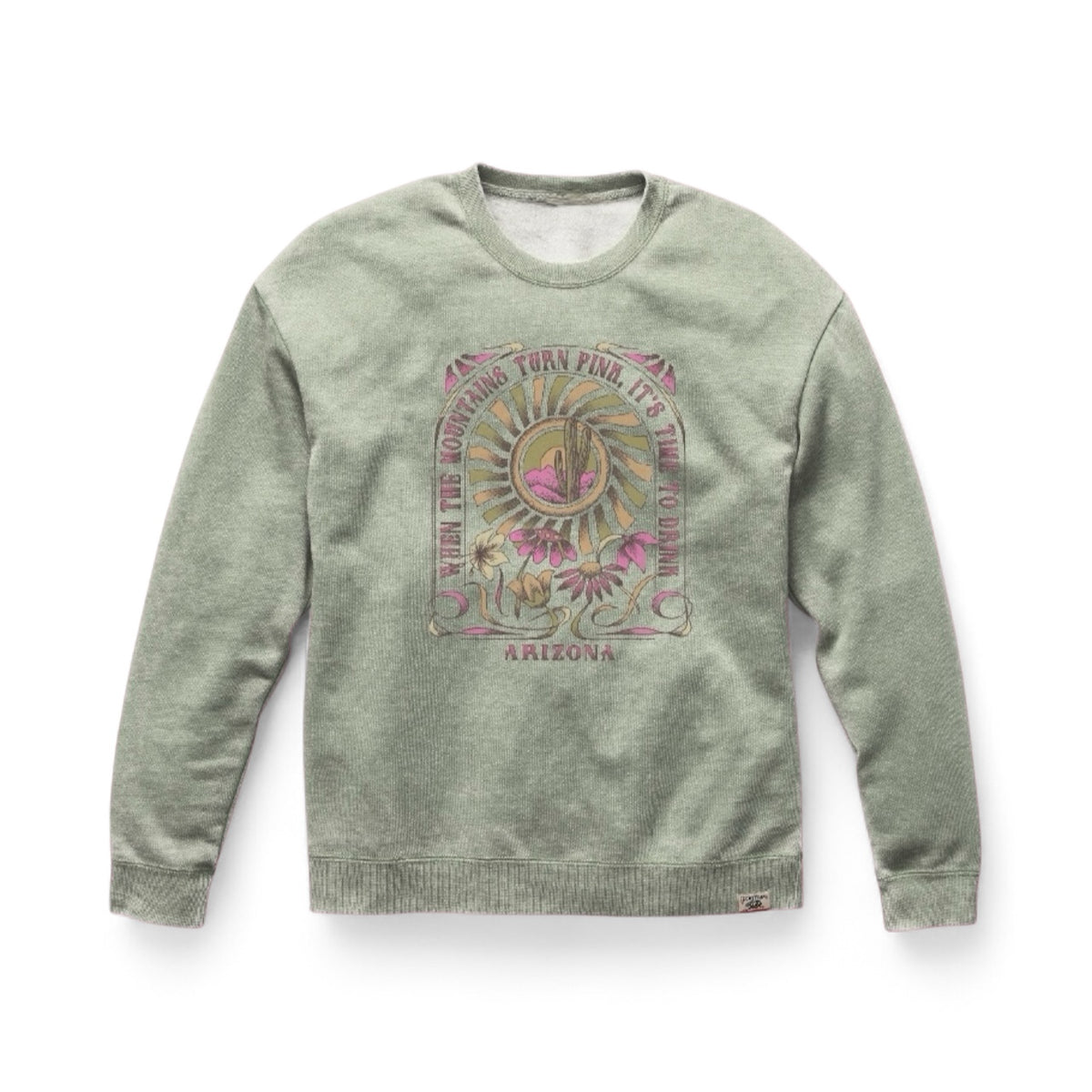 Vintage-wash sage green crewneck sweatshirt featuring an Arizona sunset graphic with a saguaro cactus, wildflowers, and retro typography.
